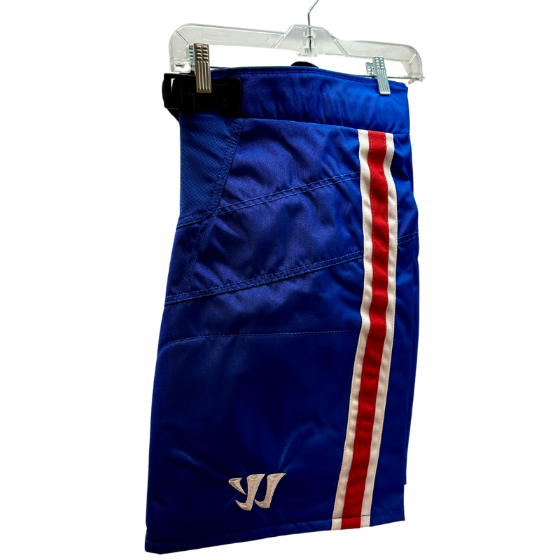 Warrior NHL Pro Return Montreal Canadiens Pant Shells folded in half showing Warrior logo, hanging from clothes hanger