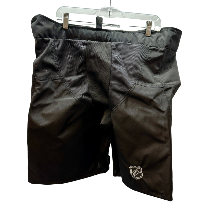 Warrior NHL Pro Return New Jersey Devils Pant Shells back hanging from a clothes hanger