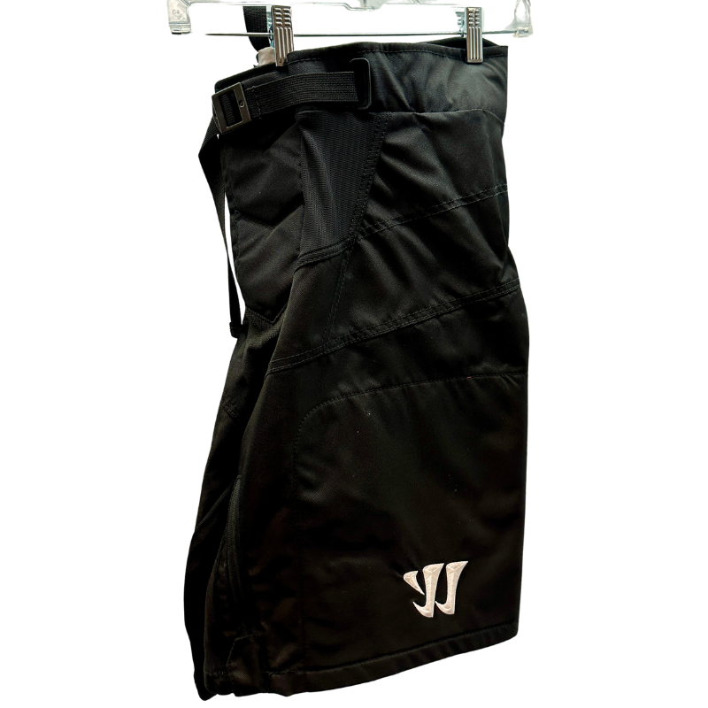 Warrior NHL Pro Return Dallas Stars Pant Shells folded in half showing Warrior logo, hanging from clothes  hanger